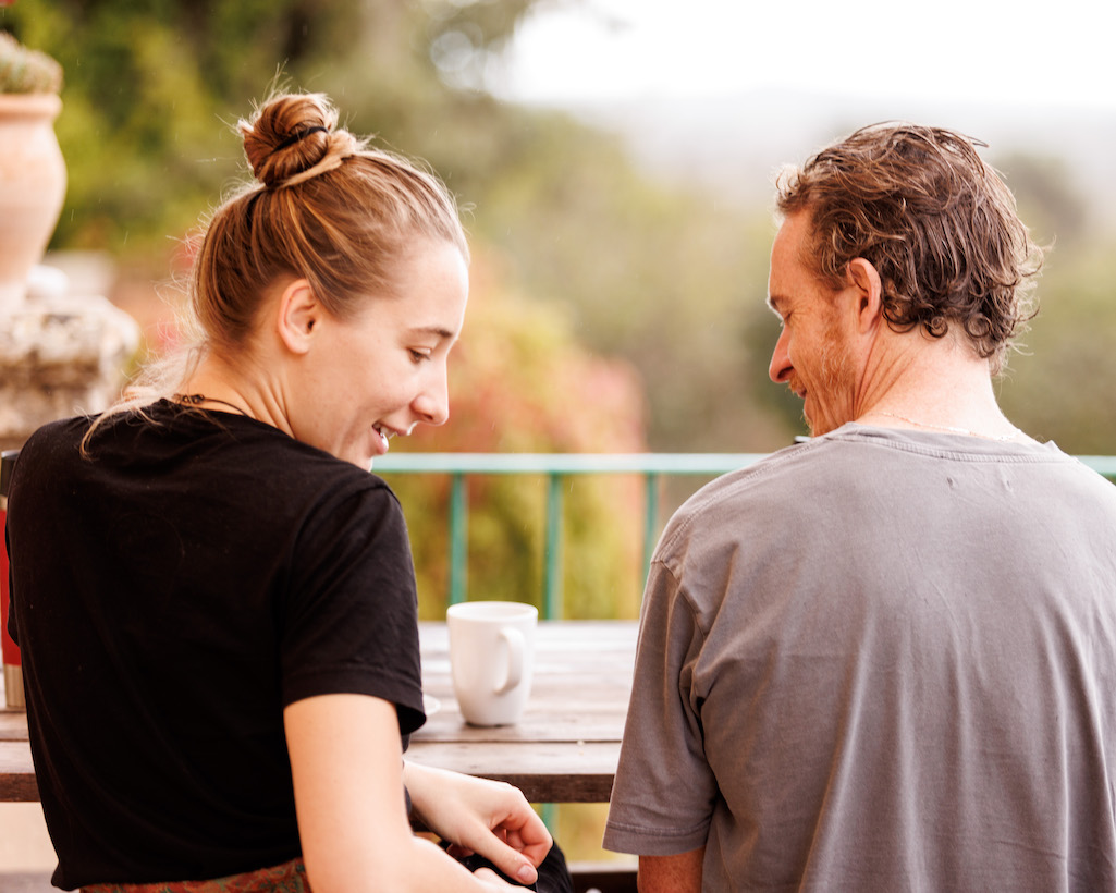 Ana and Connor connect outside on the balcony at the conscious community center of Dima Mallorca